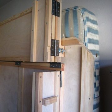 The bottom leg of the wallbed folded up and latched back