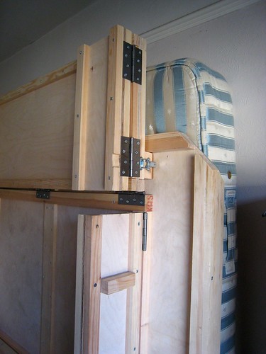 The bottom leg of the wallbed folded up and latched back