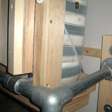 Rope replaces latches holding the head end of the wallbed round the mattress (upright position)