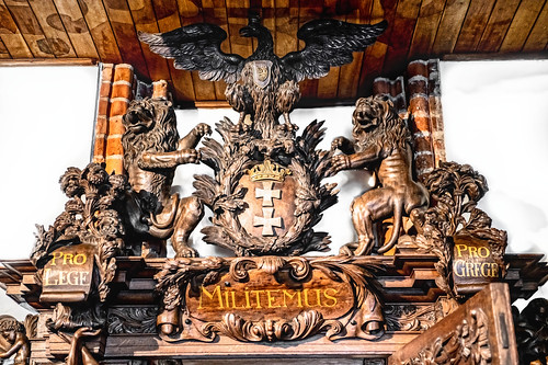 Details of the woodwork above the doorway in the Gdańsk Main Town Hall on the Royal Route, Gdańsk, Poland. 790a