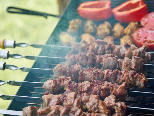 Barbecue shashlik kebab with winglets and tomatoes with roasted pepper