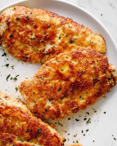 Crispy, golden Parmesan Crusted Chicken breasts taste just like schnitzel without the carb-loaded guilt!