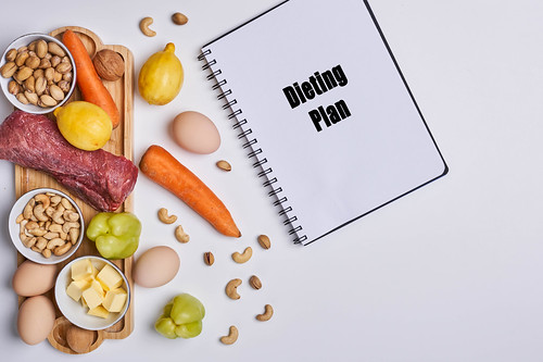 Healthy food background with dieting plan on the notepad