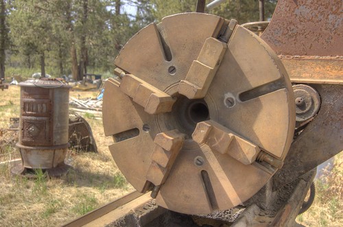 18-inch 4-jaw chuck / faceplate of a ventury-old 20-inch x 12-foot Muller metal lathe in a junkyard, made by the Bradford Mill Company