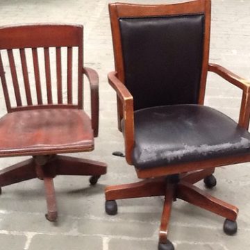 Two wooden rolling chairs