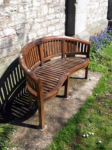 wooden bench at the side of a church