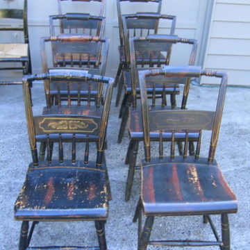 eight wooden-seated chairs