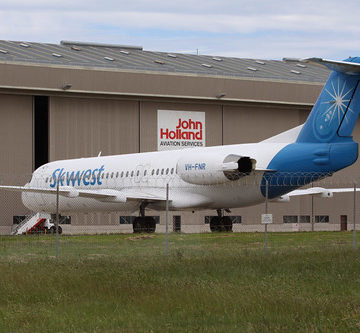 Skywest Fokker 100 VH-FNR outside the John Holland Aviation Services shed at Melbourne Airport