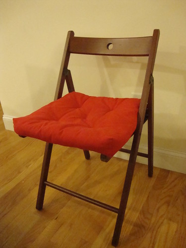 Wooden folding chair w/red cushion