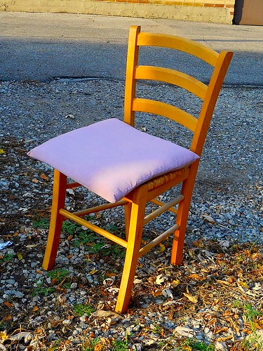 wooden chair in the trash