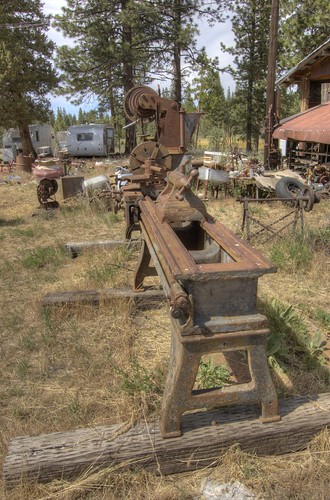 Tailstock end of a century-old 20-inch x 12-foot Muller metal lathe in a junkyard, made by the Bradford Mill Company