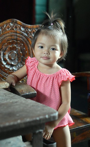 cute toddler in a carved wooden chair