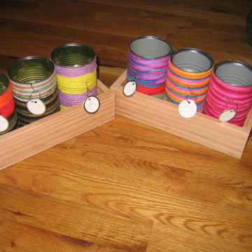 The yarn cans in their wooden holders