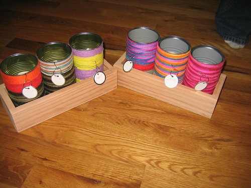 The yarn cans in their wooden holders