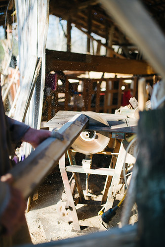 Man working on circular saw. Cutting wood closeup.