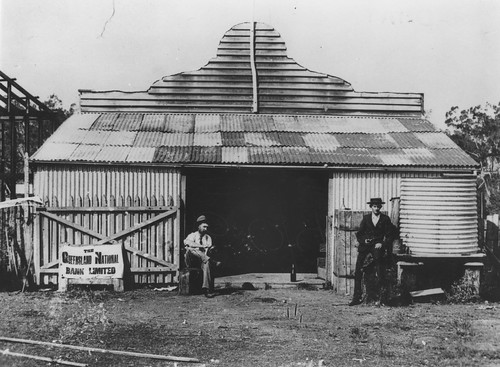 Two gentlemen pictured outside the Queensland National Bank in Yangan, 1901