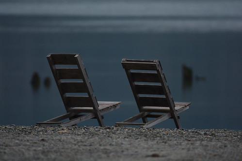 wooden chairs by the water