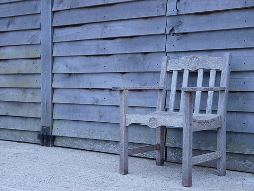 Wooden chair against wooden shed