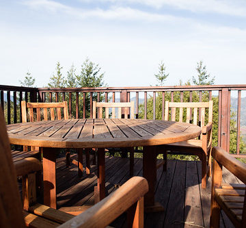 Wooden chairs around table on patio